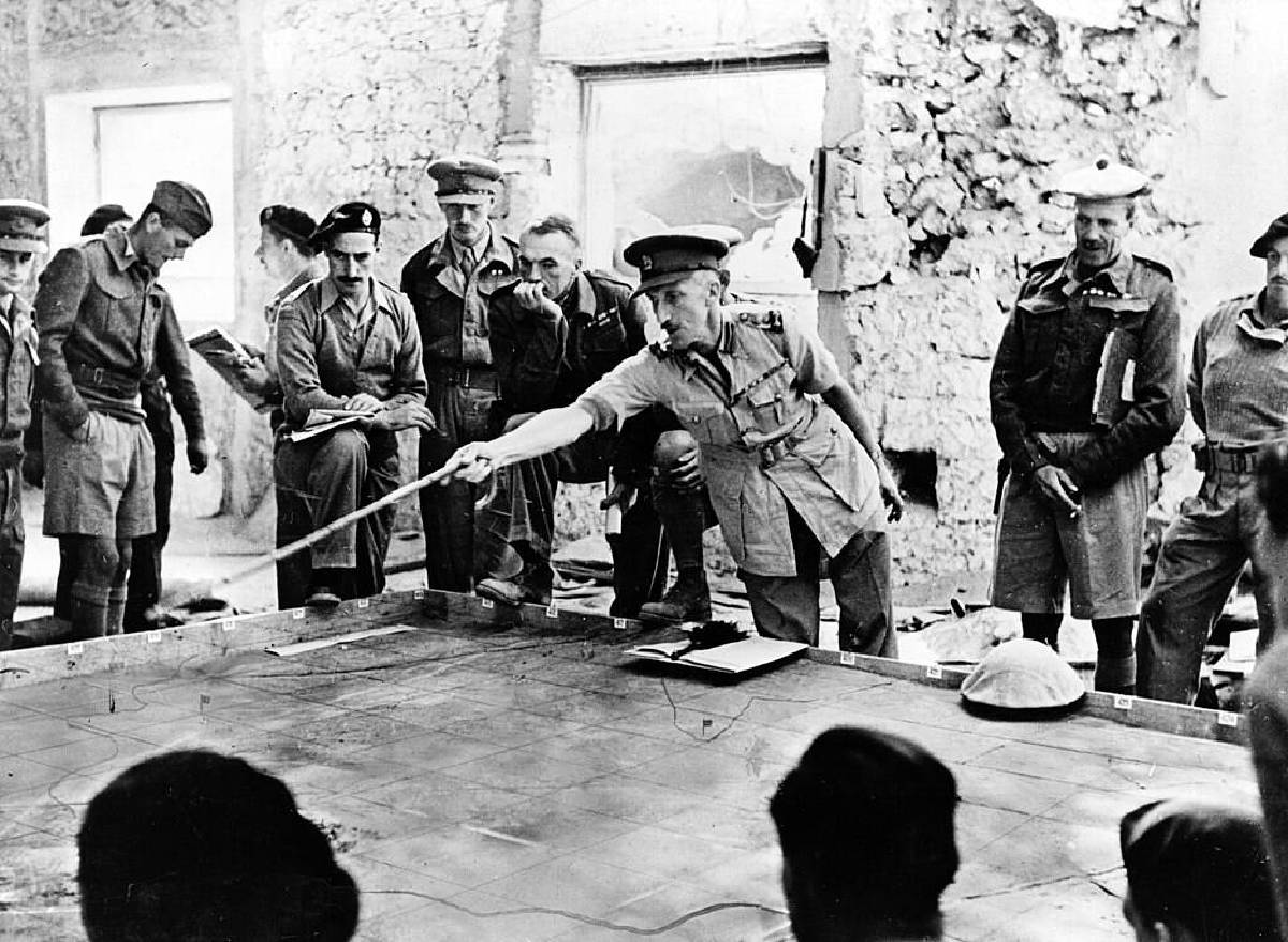 officers standing around a table planning a battle