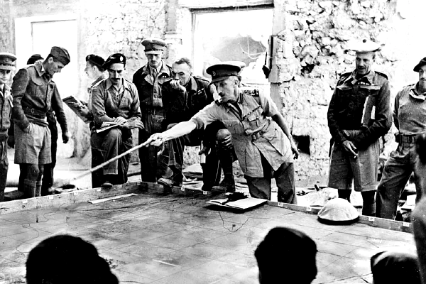 officers standing around a table planning a battle